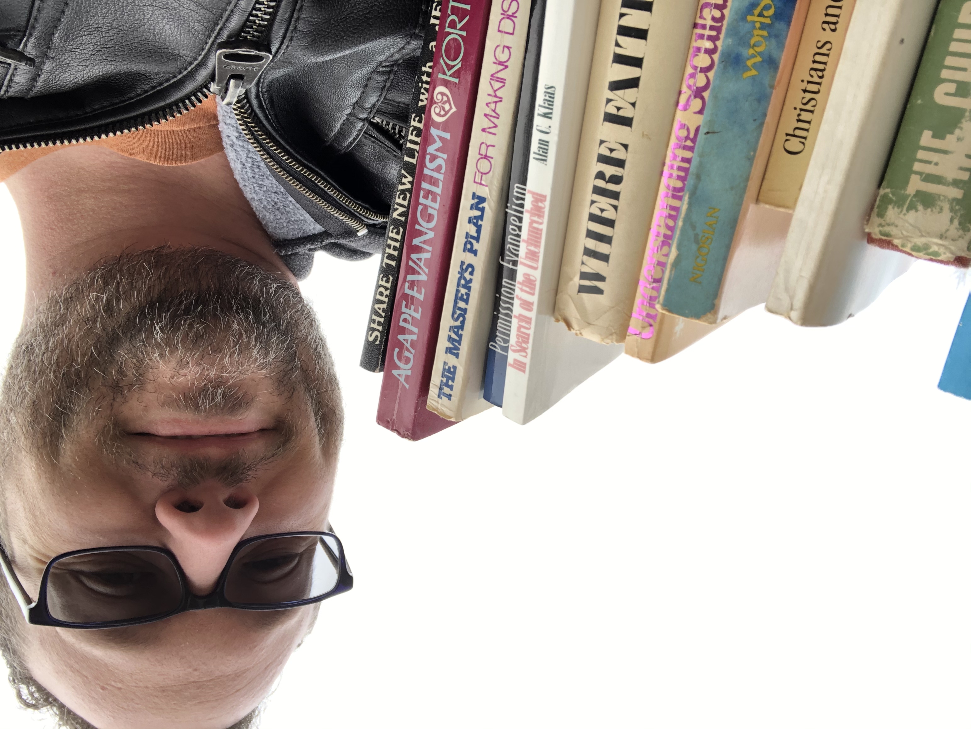 Steve Baney holding a stack of books